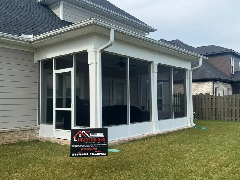 A finished Vargas Brothers screened porch with the company yard sign out front
