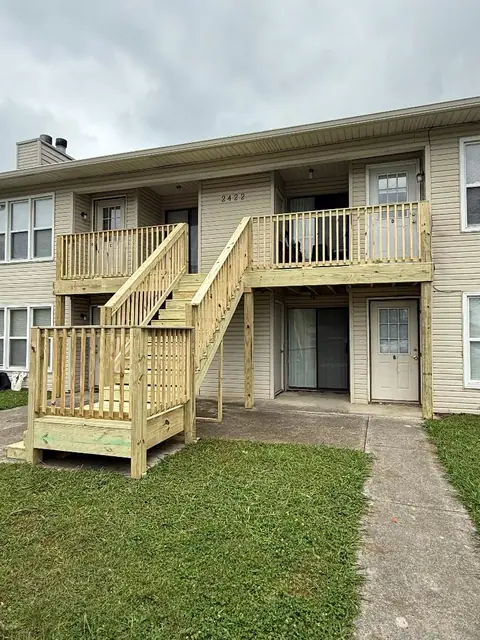 Newly built exterior wood stairs and balcony addition
