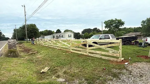 Long wood ranch fence along a road