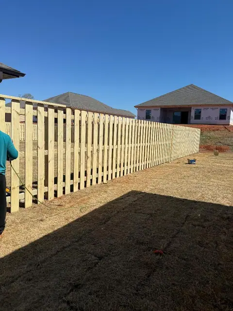 New wood shadowbox fence under a blue sky