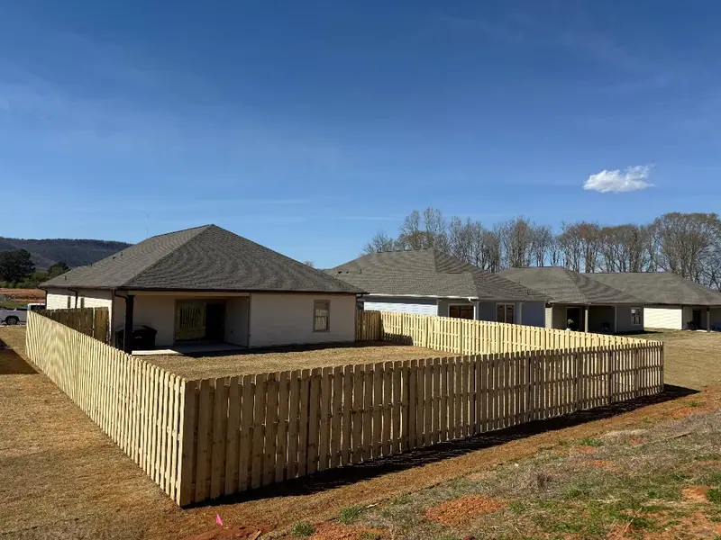 Wood shadowbox privacy fence with mountains behind it
