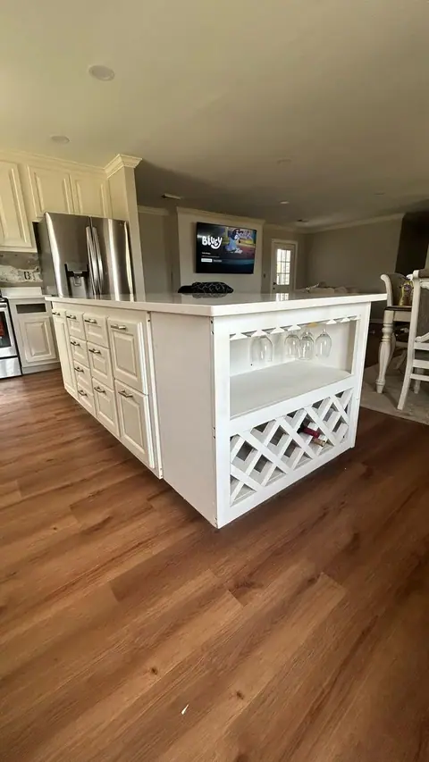 Large white kitchen island with a wine rack